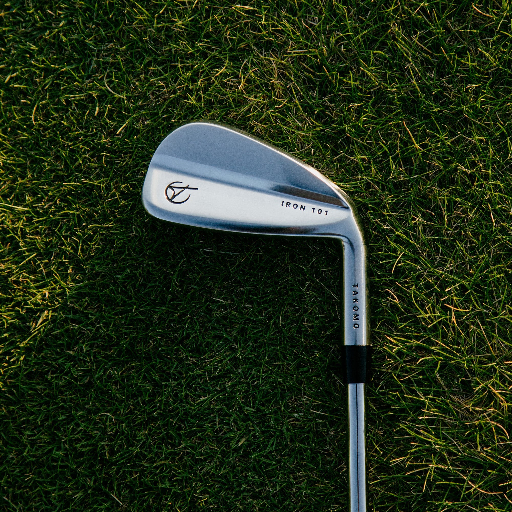 Golf club on a grassy background