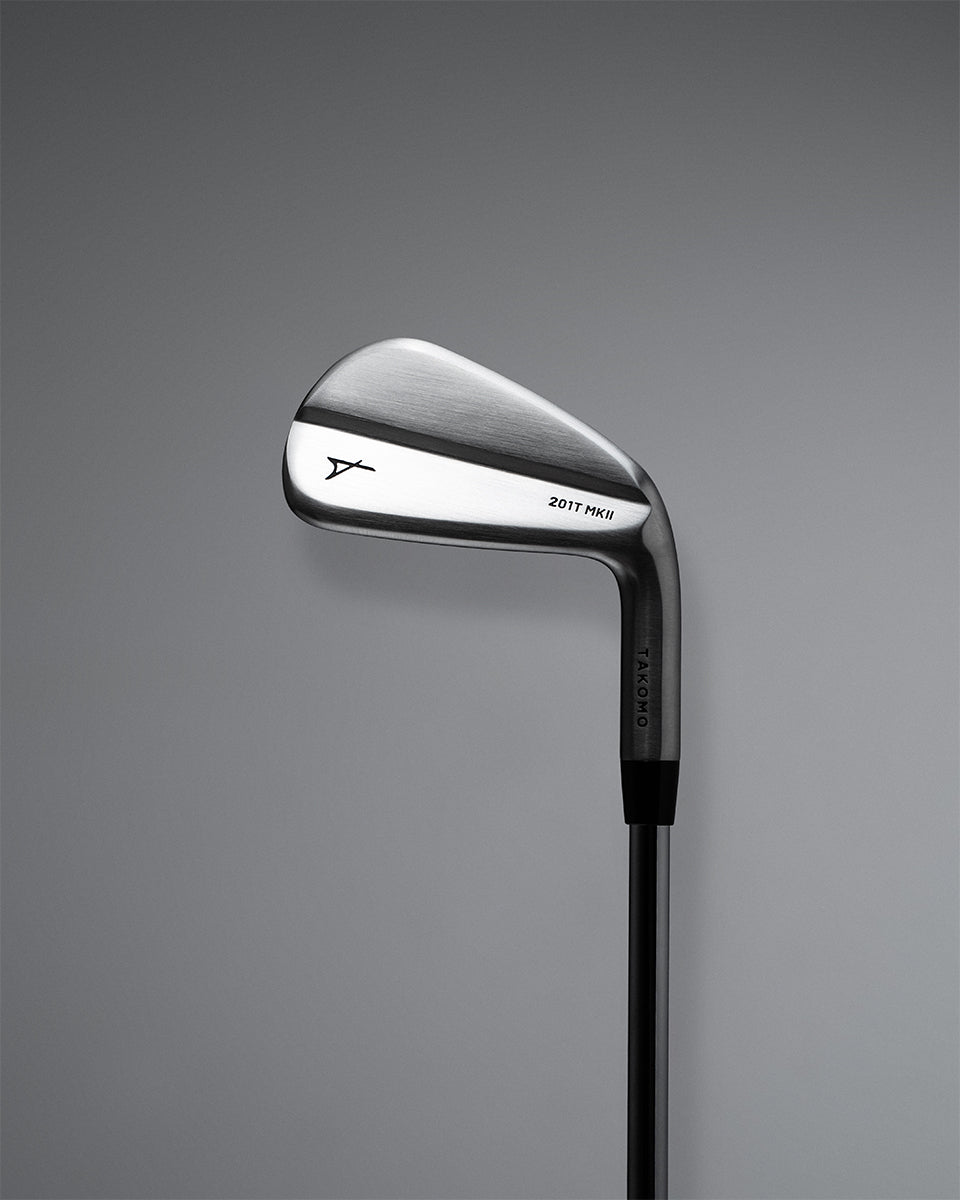 A Takomo Iron 201T MKII golf club shown from a side profile view against a dark gray gradient background.
