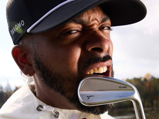 A man biting on the takomo 101 mkii iron