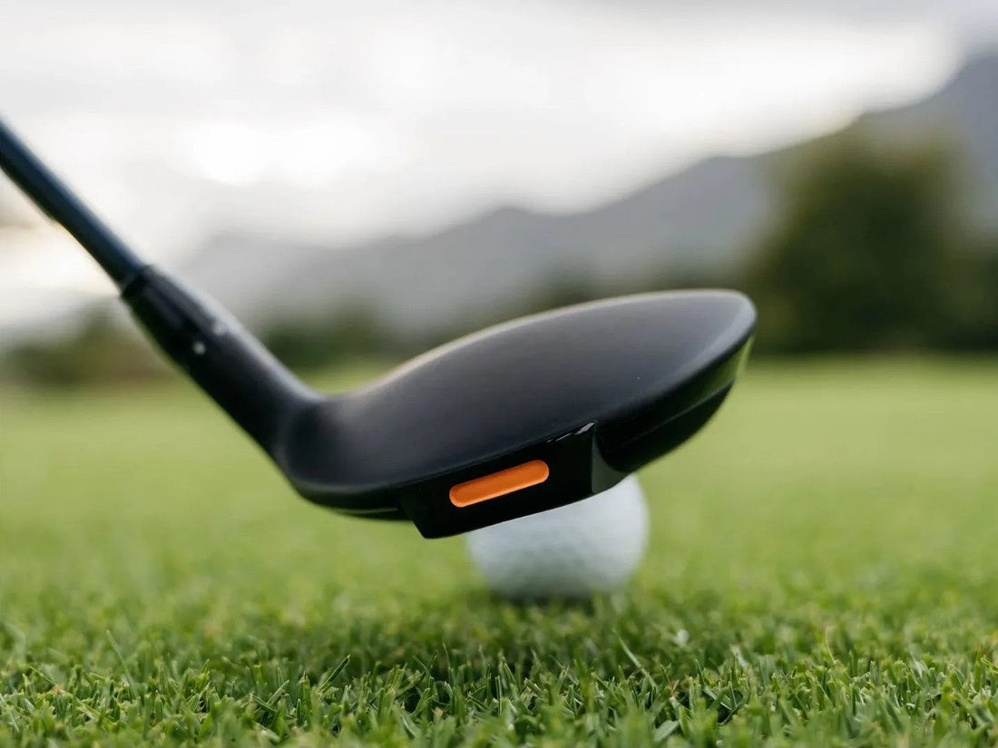 Fairway wood at address behind a golf ball comparing 5 wood vs 7 wood distance