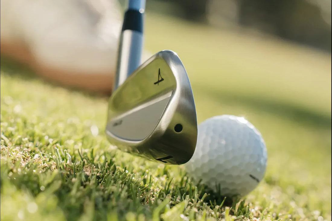 photo-takomo-white-stand-bag-laying-on-grass-with-golf-balls-and-irons