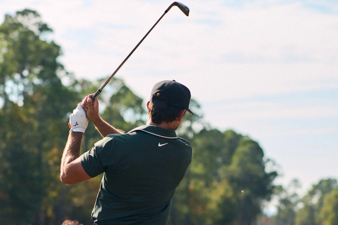 photo man in green shirt swinging golf club for iron distances