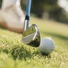 Golf club and ball on a grassy surface