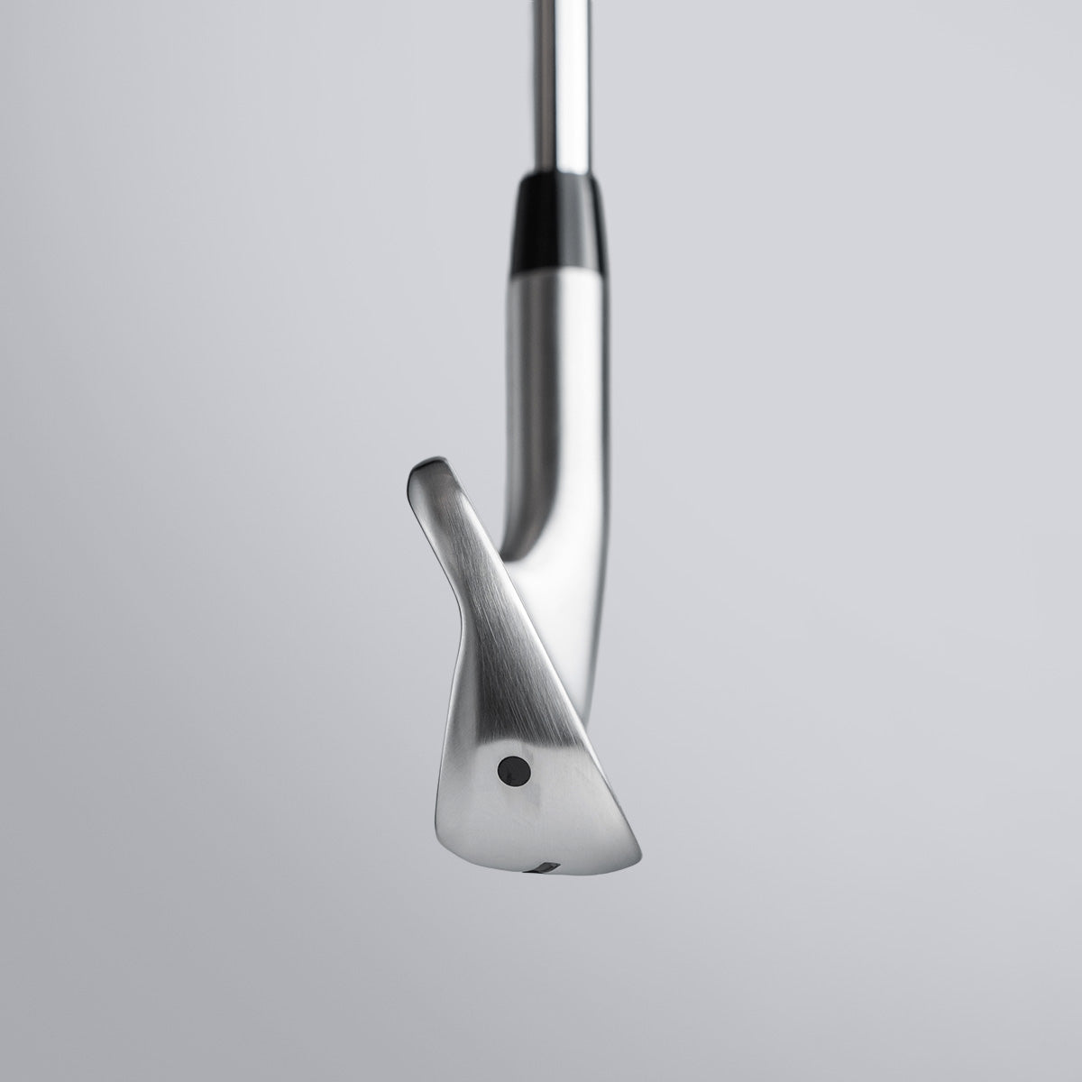 Close-up of a golf club head on a light gray background