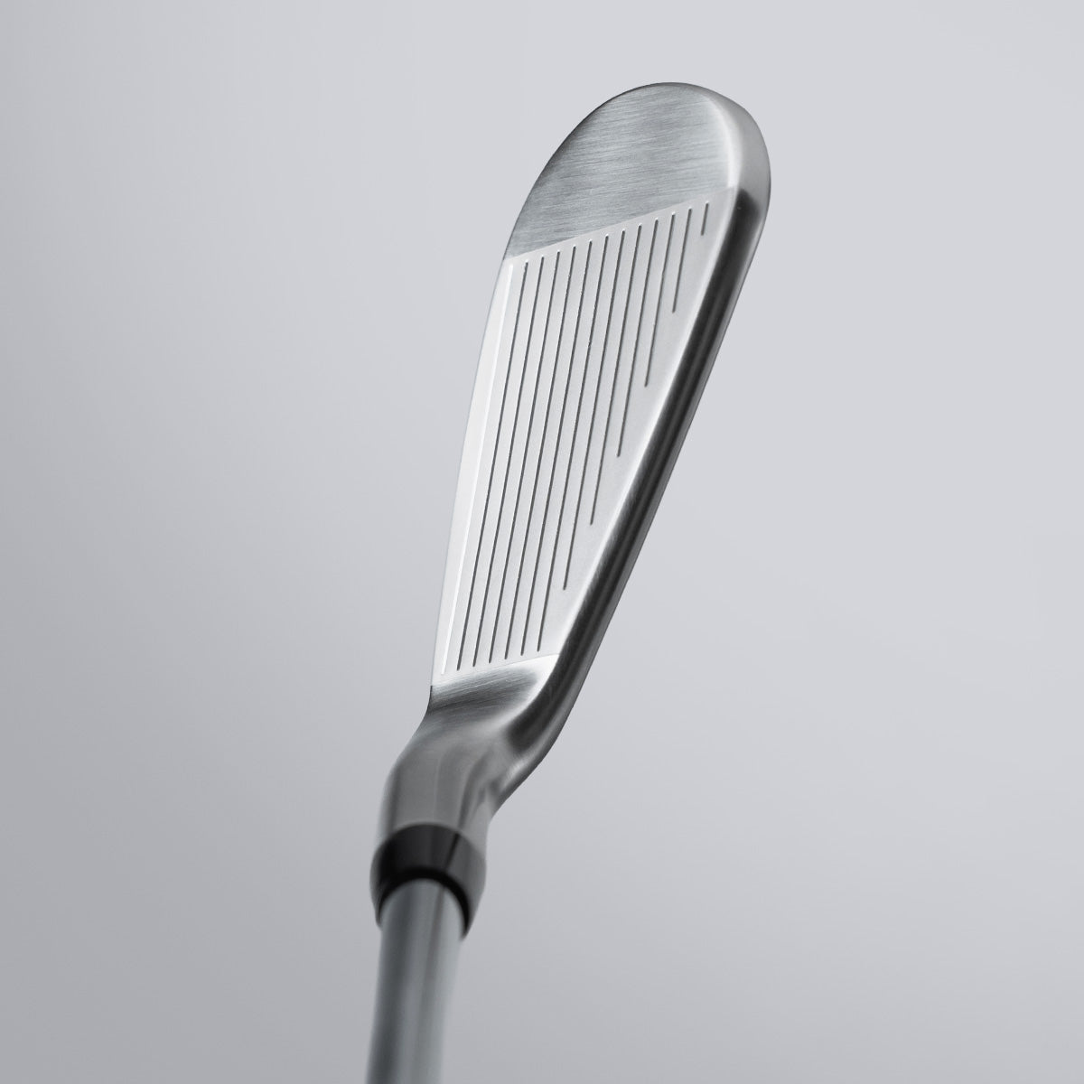 Close-up of a golf club head on a light gray background