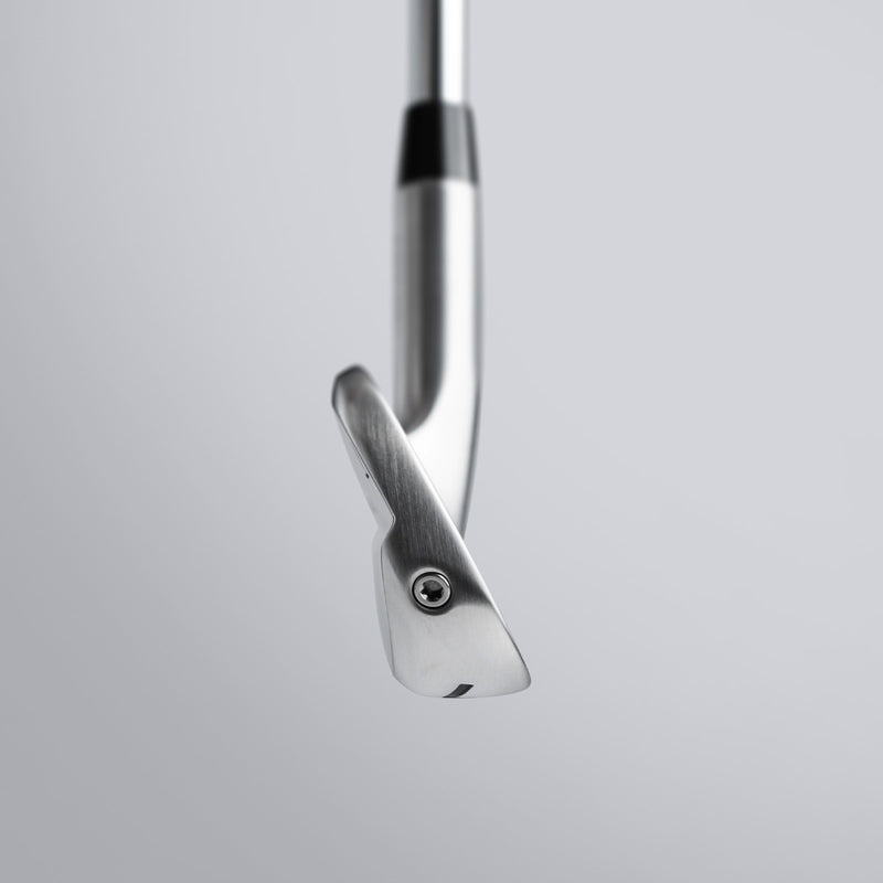 Close-up of a golf club head on a light gray background