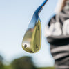 Close-up of a golf club head with a blurred background