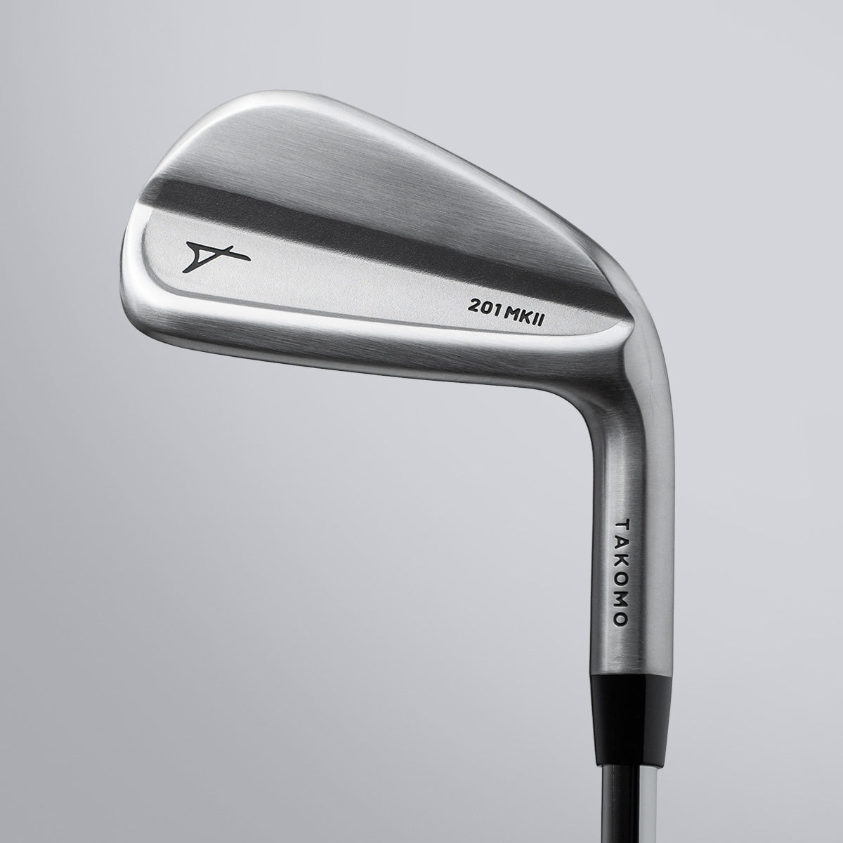 Golf club head with 'Takomo' branding on a gray background