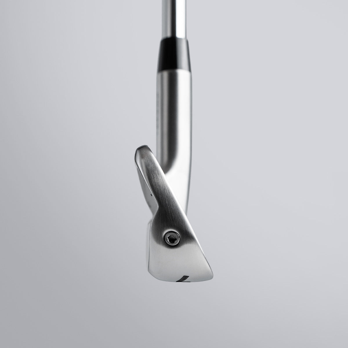 Close-up of a golf club head on a light gray background