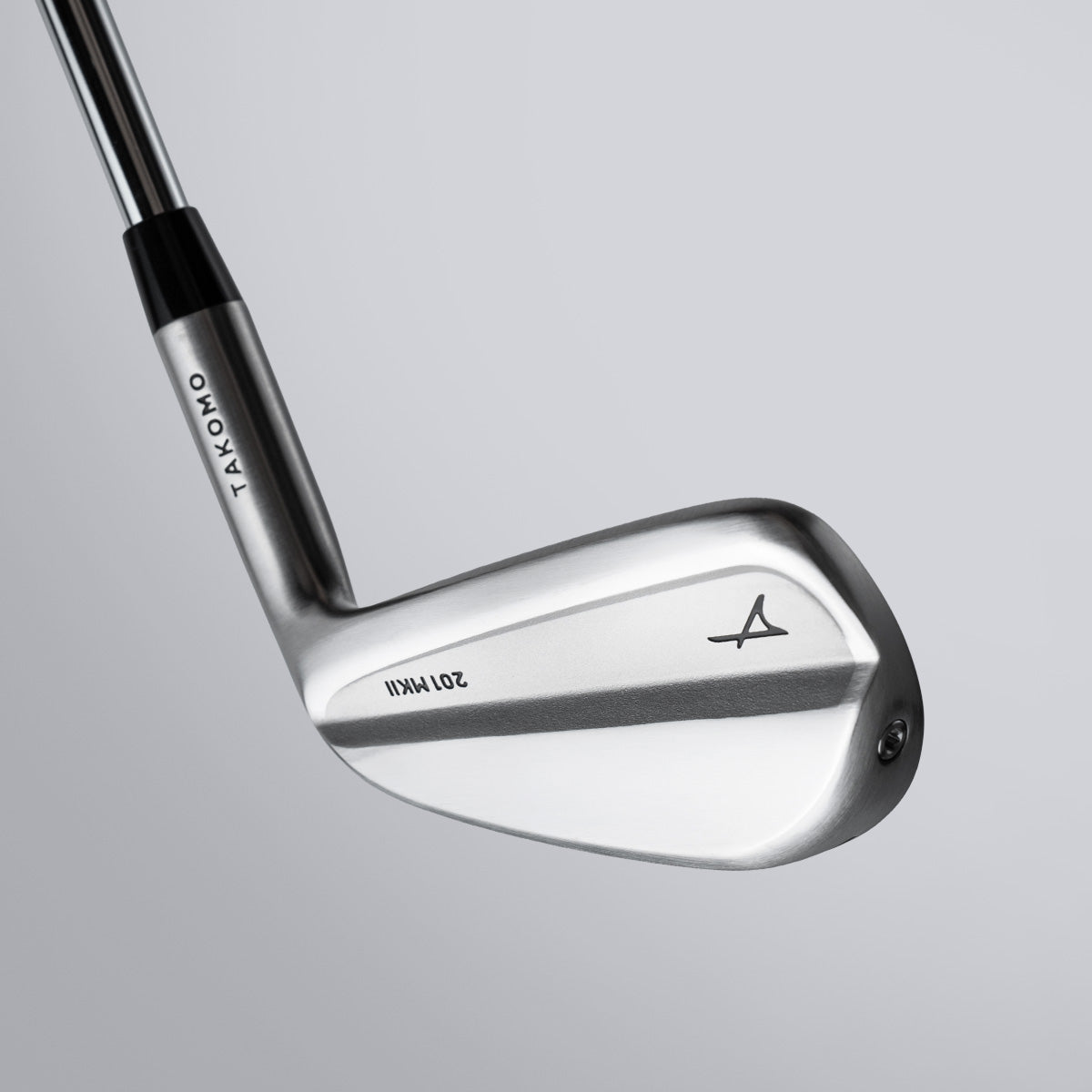 Golf club with Takomo branding on a gray background