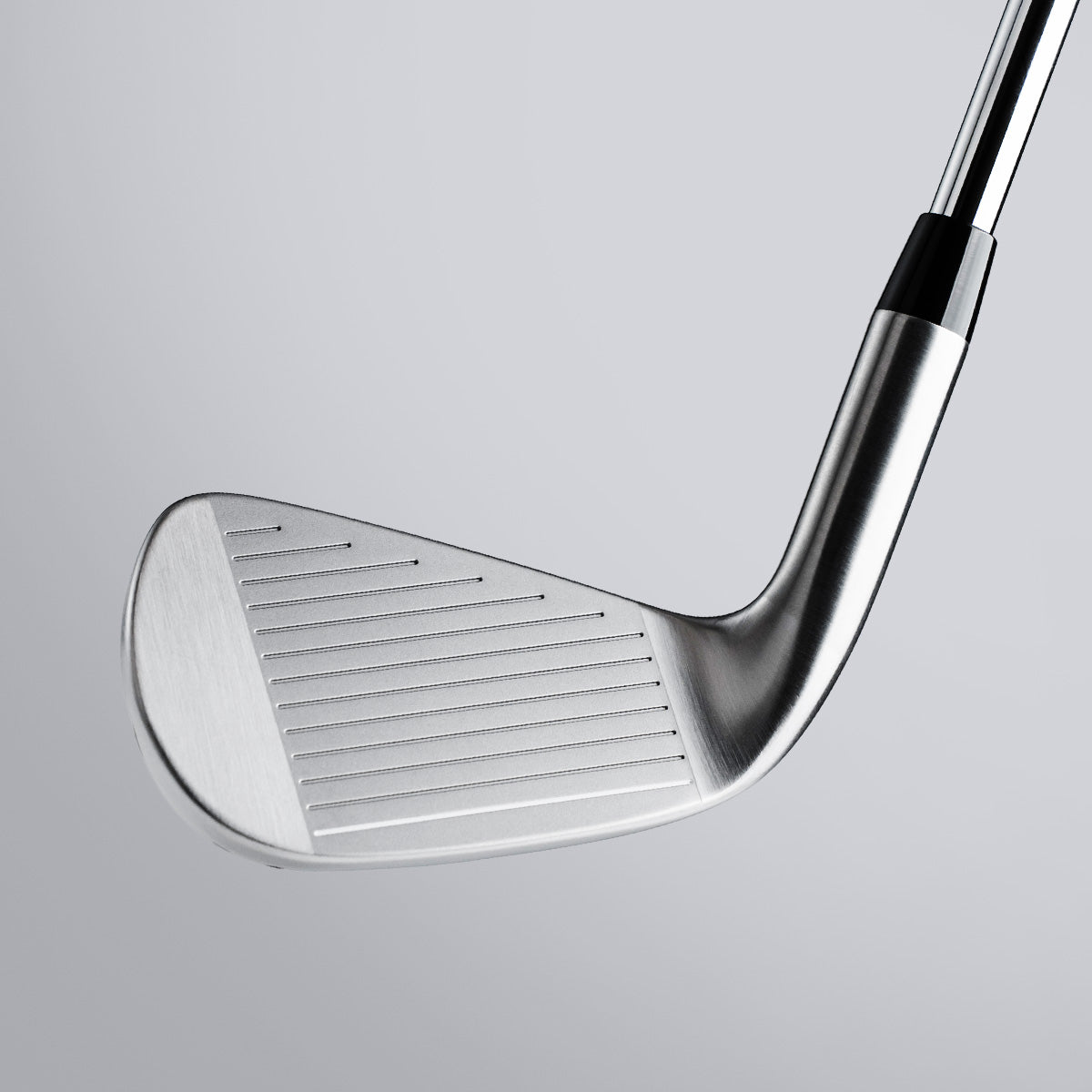 Close-up of a golf club on a light gray background