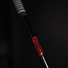 Close-up of a golf club shaft with 'KBS' branding on a black background