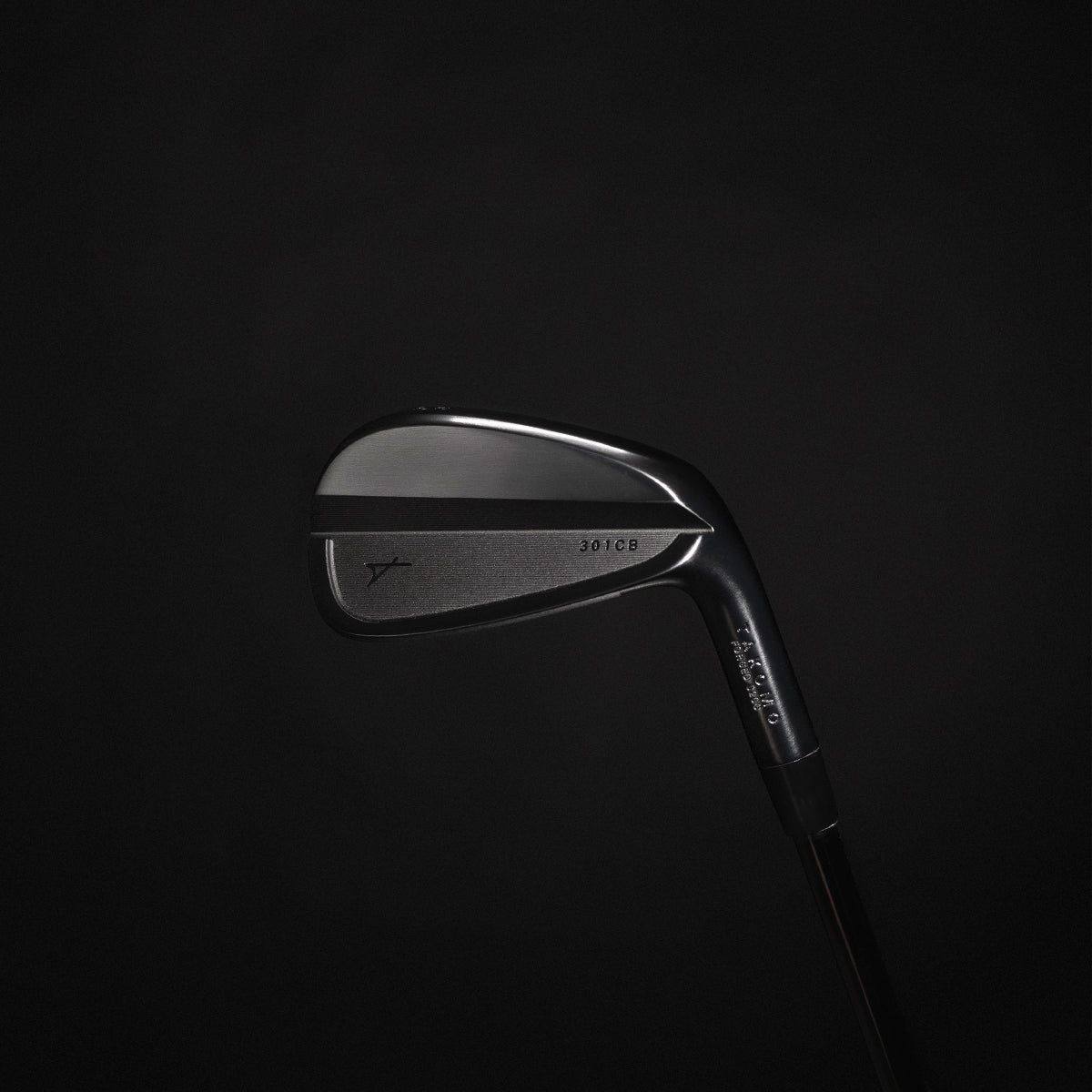 Golf club head on a black background