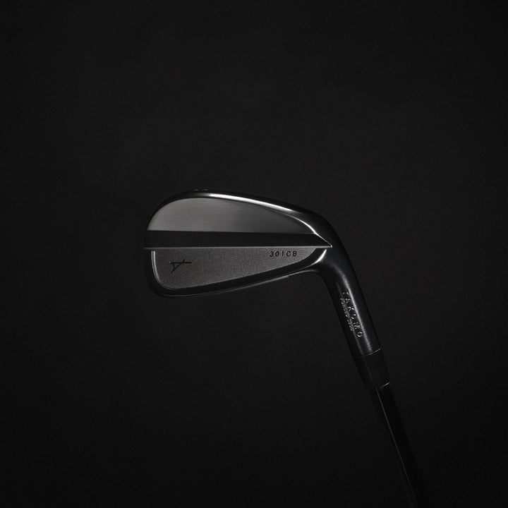 Golf club head on a black background
