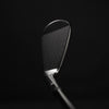 Golf club head on a black background