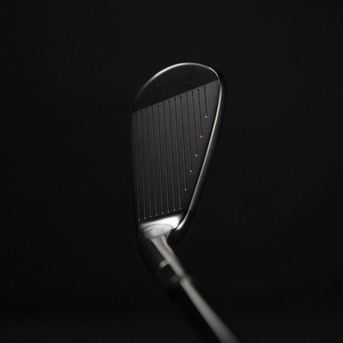 Golf club head on a black background