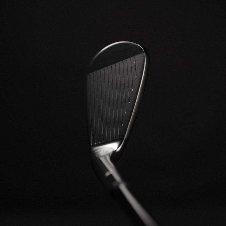 Golf club head on a black background