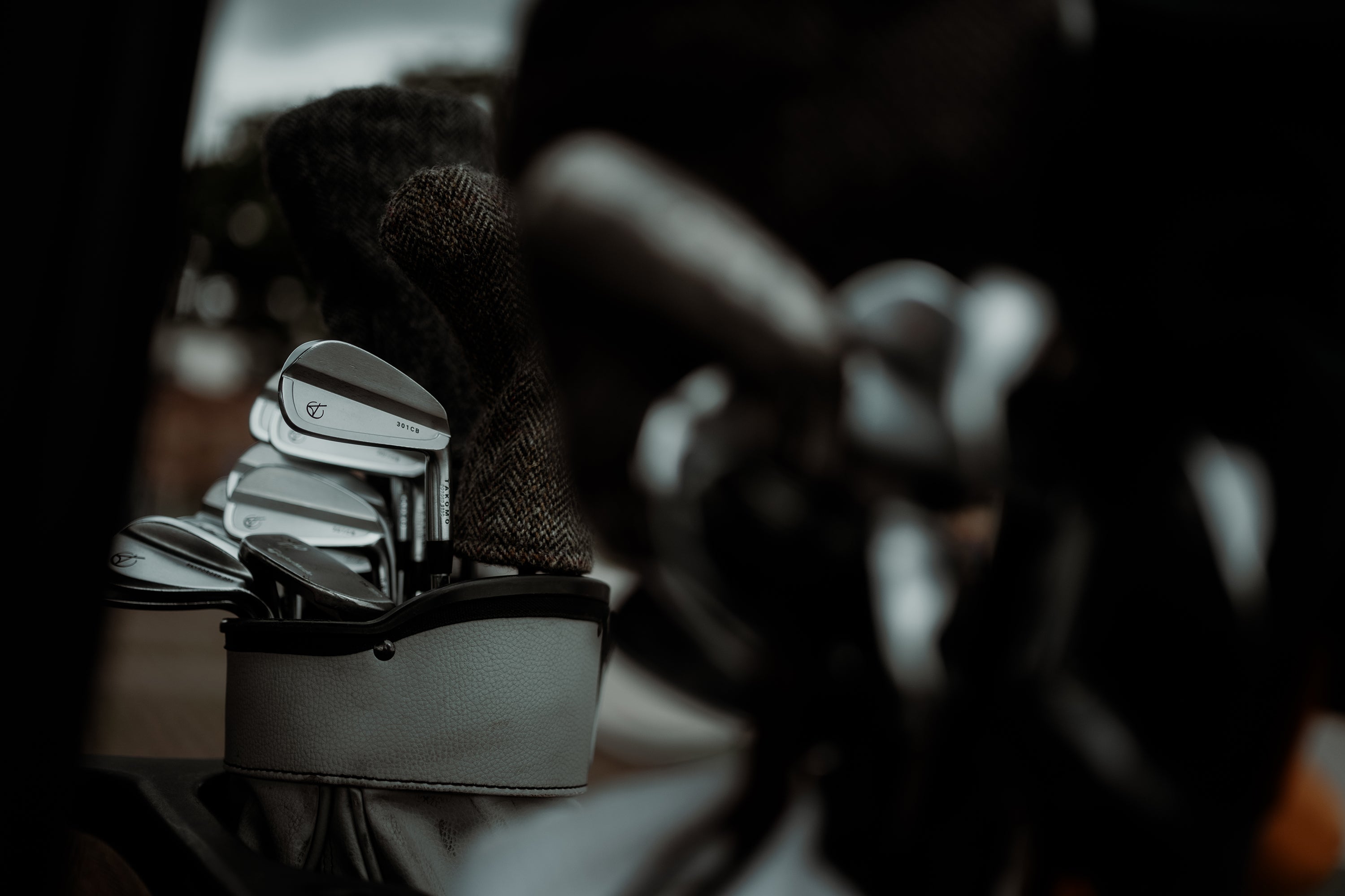 Close-up of golf clubs in a bag with blurred background