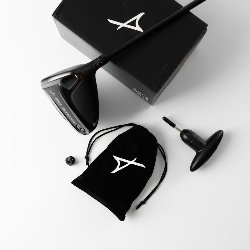 A black Takomo IGNIS D2 driver head with related accessories laid neatly on a white background.