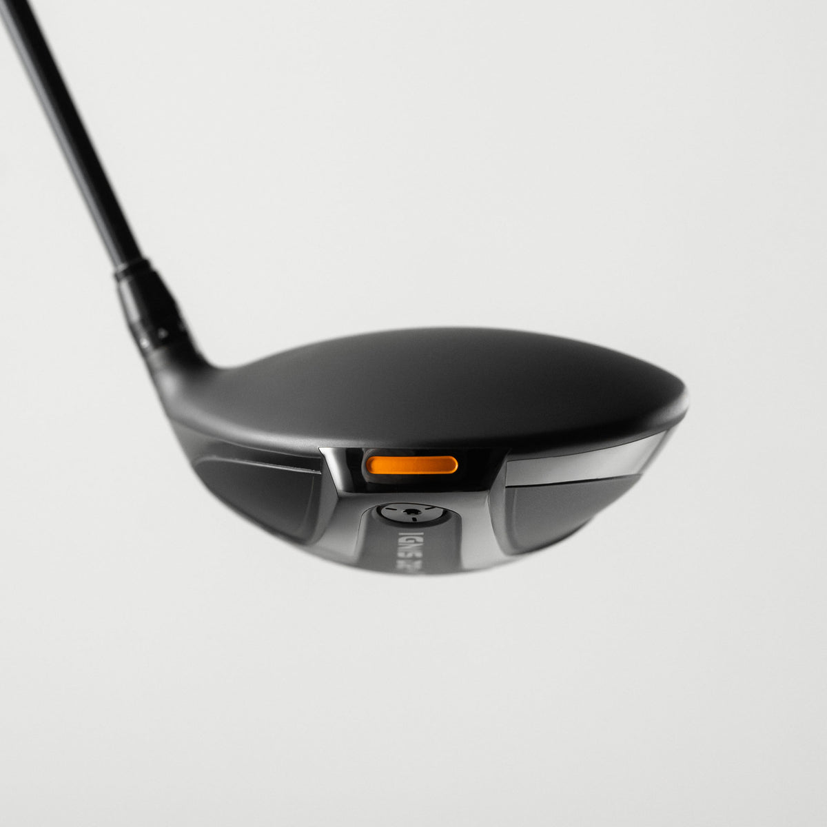 A close-up studio shot of a Takomo IGNIS D2 golf driver head with a small orange accent, shown against a light gray background.