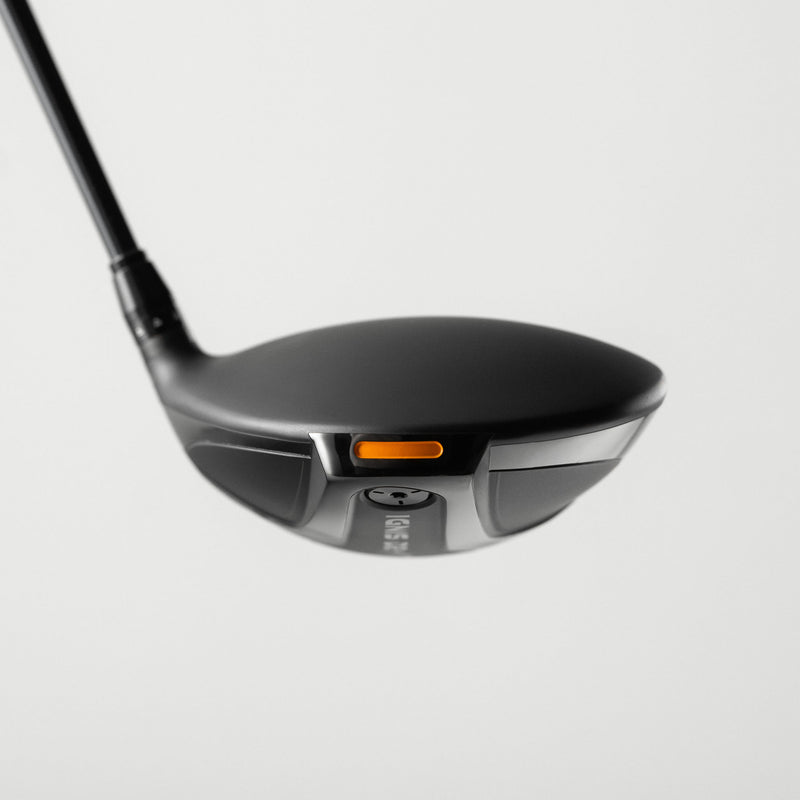 A close-up studio shot of a Takomo IGNIS D2 golf driver head with a small orange accent, shown against a light gray background.
