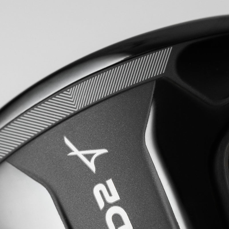 Close-up of a black golf club head showing the Takomo logo and part of the 'D2' model number, with line detailing in focus.