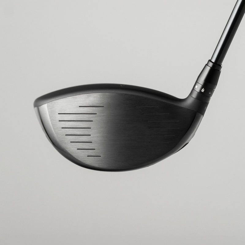 A close-up studio shot of a Takomo IGNIS D2 club head with part of the shaft visible, set against a solid light gray background.