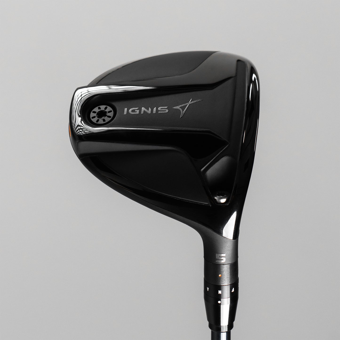 Black golf club head with 'IGNIS' branding on a gray background