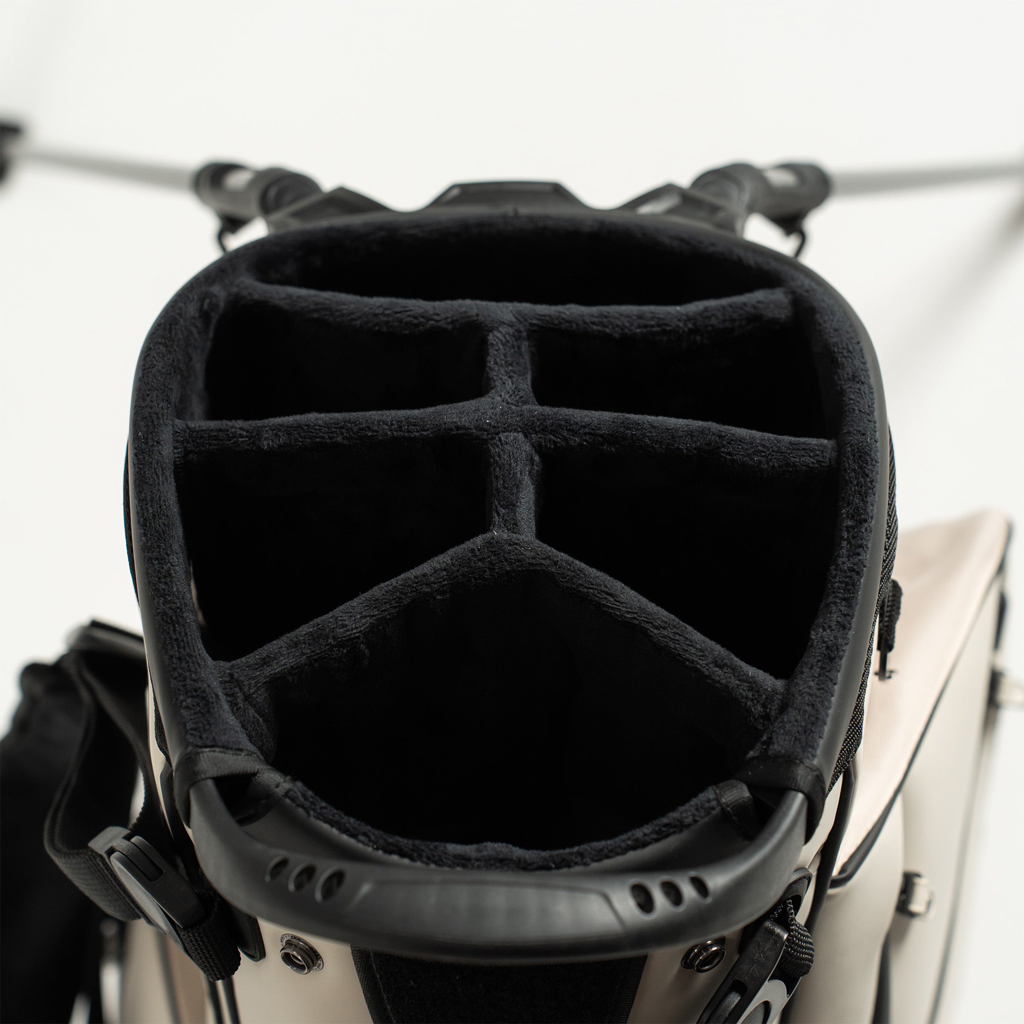 Close-up of a golf bag with multiple compartments on a white background