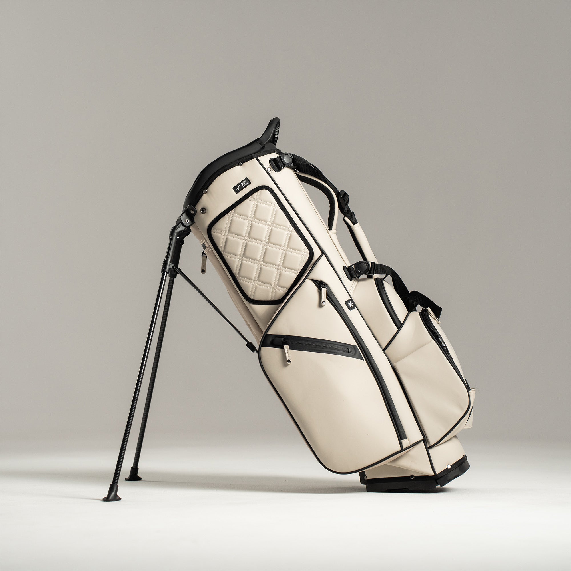 White golf bag with black accents on a gray background