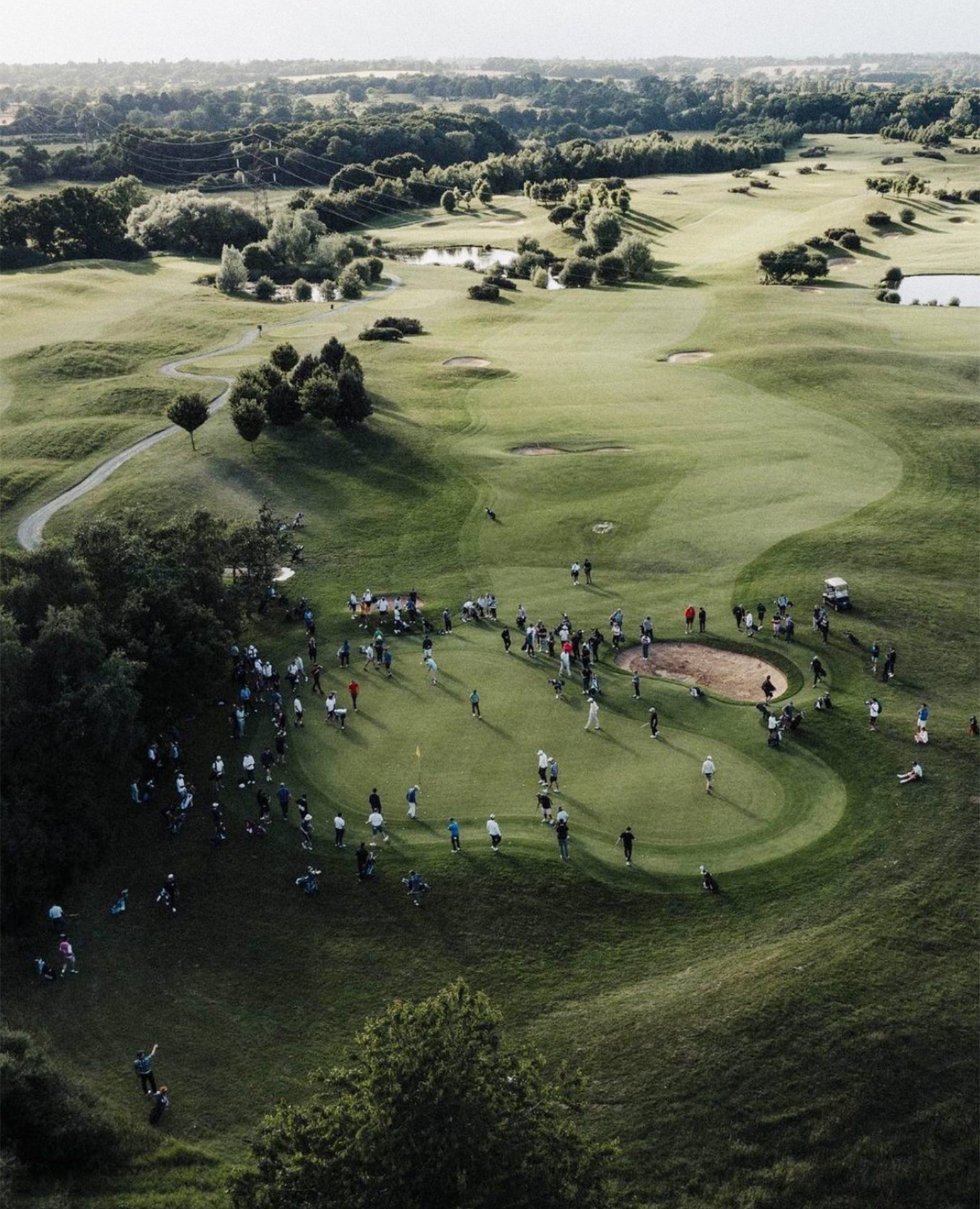 Aerial view of a golf course with players on the green