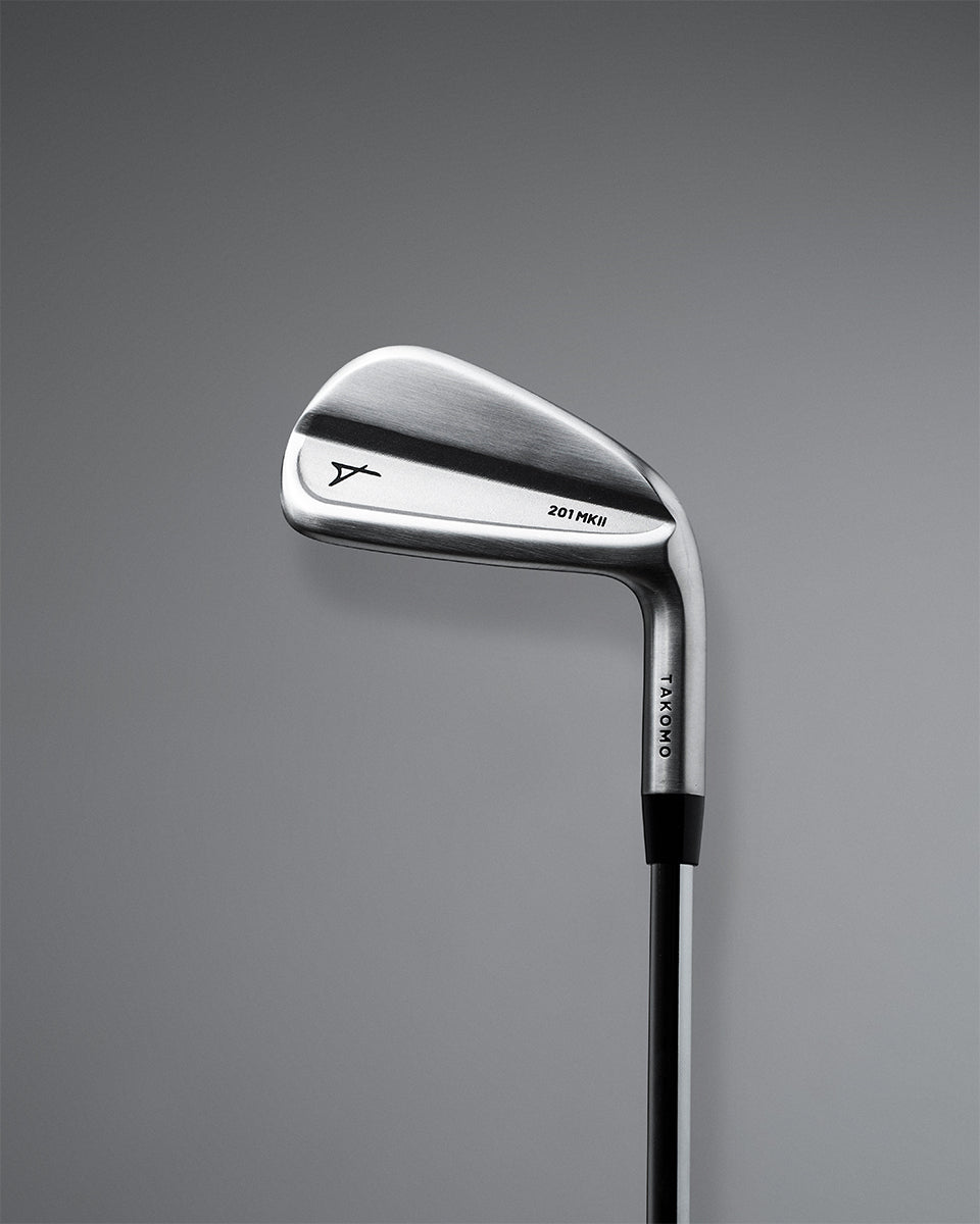A Takomo Iron 201 MKII golf club shown from a side profile view against a dark gray gradient background.