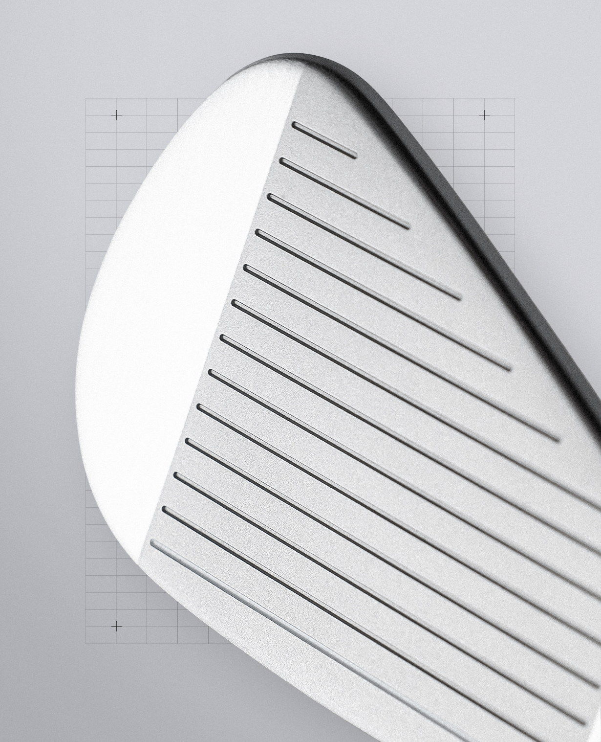 Close-up of a golf iron club head showing the white face, bevel, and milled slot grooves on a light gray background.